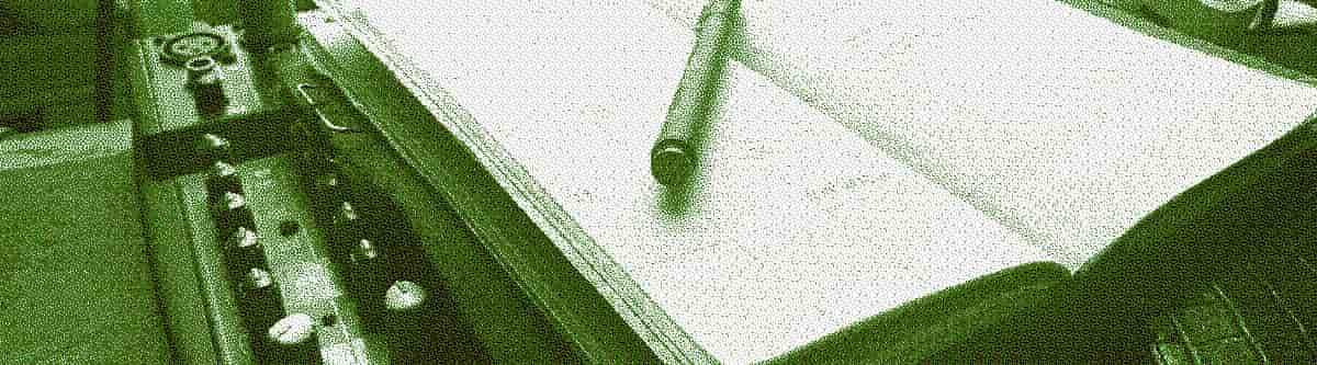 An open diary sits on top of an audio mixing desk.